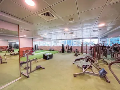 a gym with treadmills and machines in a room at Beautiful Home at the Heart of Marina in Dubai