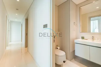 a bathroom with a toilet and a sink at Classy 3BR with Assistant Room at Sunrise Bay Tower 1 Emaar Beachfront, Dubai Marina by Deluxe Holiday Homes in Dubai