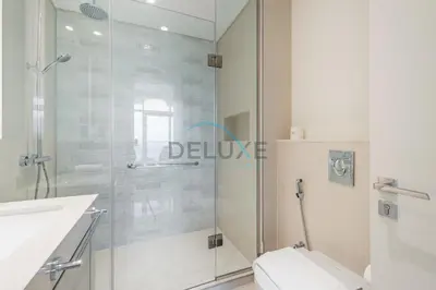 a bathroom with a shower and a toilet and a sink at Classy 3BR with Assistant Room at Sunrise Bay Tower 1 Emaar Beachfront, Dubai Marina by Deluxe Holiday Homes in Dubai