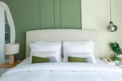 a bedroom with a bed with white sheets and pillows at Studio Hotel Apartment Brand New Azizi Riv 14 in Dubai