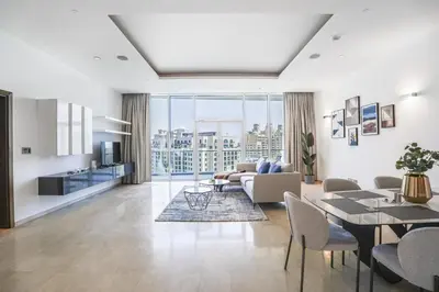 a living room with a couch and a table at Oceana Baltic Palm West Beach Views 3 bd Sleeps 7 in Dubai