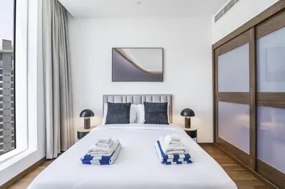 a bedroom with a large white bed and a window at Oceana Baltic Palm West Beach Views 3 bd Sleeps 7 in Dubai