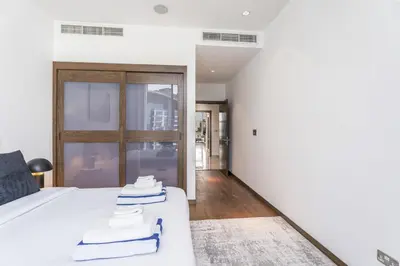 a bedroom with a white bed with towels on it at Oceana Baltic Palm West Beach Views 3 bd Sleeps 7 in Dubai