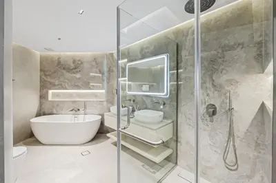 a bathroom with a shower and a toilet and a sink at Luxury at Beachside Al Sultana Jumeirah Shoreline - DVH Holiday Homes in Dubai