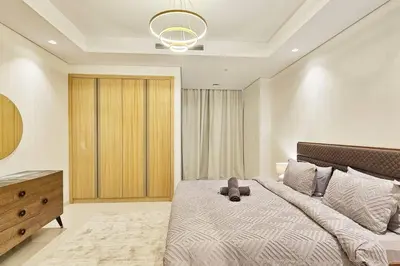 a bedroom with a large bed and a dresser in it at Luxury 2BR Midtown Apartment in Dubai