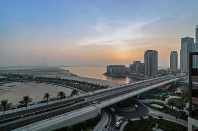a city with a bridge over a river and buildings at Breathtaking Dubai Skyline view apartment - By DuStay in Dubai
