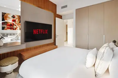 a bedroom with a netflix sign on the wall at Breathtaking Dubai Skyline view apartment - By DuStay in Dubai