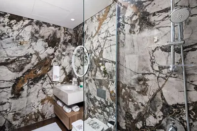 a bathroom with a sink and a shower at Breathtaking Dubai Skyline view apartment - By DuStay in Dubai