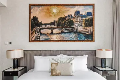 a painting above a bed in a hotel room at Luxury Apartment at Dubai Creek Harbour, Bayshore - By DuStay in Dubai