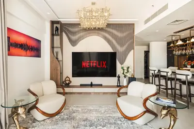 a lobby with a television and chairs and a table at Luxury Apartment at Dubai Creek Harbour, Bayshore - By DuStay in Dubai