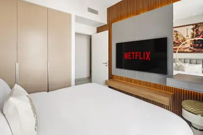 a bedroom with a bed with a television on the wall at Luxury Apartment at Dubai Creek Harbour, Bayshore - By DuStay in Dubai