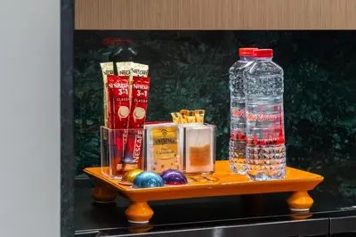 a table with a bottle of water and balls and chips at Stylish Poolside Apartment in Dubai Creek Harbour - By DuStay in Dubai