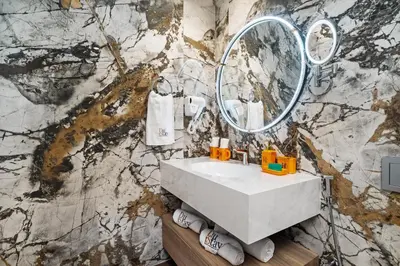 a bathroom with a sink and a mirror at Luxury Getaway Apartment at Dubai Creek Harbour - By Dustay in Dubai