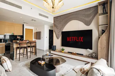a living room with a netflix sign on the wall at Luxury Getaway Apartment at Dubai Creek Harbour - By Dustay in Dubai
