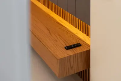 a wooden drawer with a black bottle in it at Luxury Getaway Apartment at Dubai Creek Harbour - By Dustay in Dubai