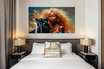 a bedroom with a bed with a painting on the wall at Luxury, Spacious Apartment in Dubai Creek Harbour - By DuStay in Dubai