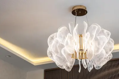 a large white chandelier hanging from a ceiling at Luxury, Spacious Apartment in Dubai Creek Harbour - By DuStay in Dubai