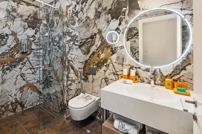 a bathroom with a sink and a mirror at Luxury, Spacious Apartment in Dubai Creek Harbour - By DuStay in Dubai