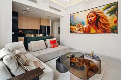 a living room with a large painting on the wall at Luxury, Spacious Apartment in Dubai Creek Harbour - By DuStay in Dubai