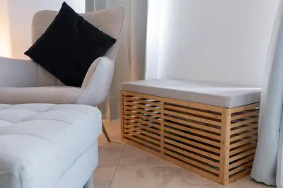 a living room with a couch and a chair at StayShort - Cozy 1-Bedroom Apartment for 5 in Motor City! in Dubai