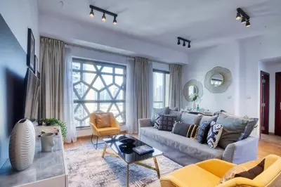 a living room with a couch and a table at The Smart Concierge - Bahar 6 in Dubai