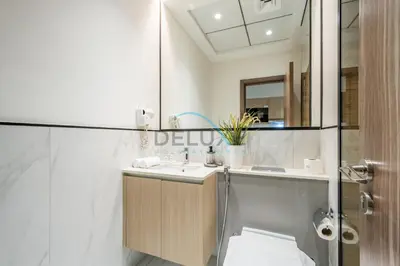 a bathroom with a sink and a shower at Modern Loft-Style Studio at Aria Residence, Jumeirah Village Circle by Deluxe Holiday Homes in Dubai