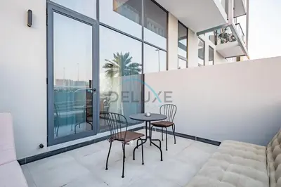 a dining room with a table and chairs at Modern Loft-Style Studio at Aria Residence, Jumeirah Village Circle by Deluxe Holiday Homes in Dubai