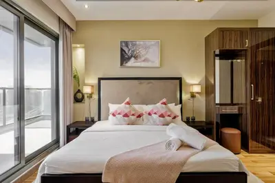 a bedroom with a large bed and a large window at Cozy 2BR in Elite Downtown Residence with Canal view in Dubai