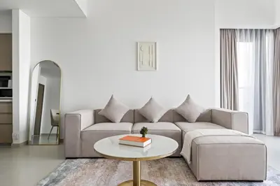 a living room with a couch and a table at Peaceful Dunes 2 - Near Burj Khalifa & Dubai Mall in Dubai