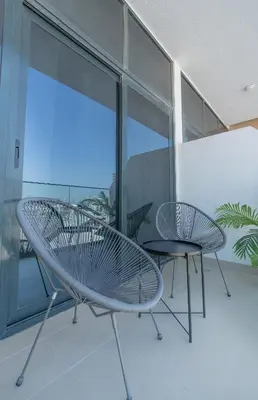 a room with two chairs and a table on a balcony at Nasma Luxury Stays - Azizi Riviera 6 Cozy Studio with Burj Khalifa View in Dubai
