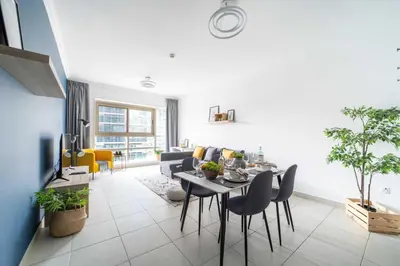 a living room with a table and chairs at Frank Porter - Marina Quays West Tower in Dubai