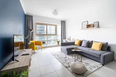 a living room with a couch and a table at Frank Porter - Marina Quays West Tower in Dubai
