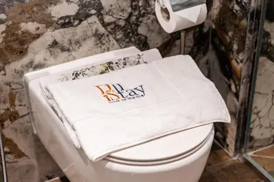 a towel on top of a toilet in a bathroom at Elegant 2-Bedroom Apartment in Dubai Creek Harbour - By Dustay in Dubai