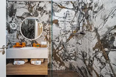 a bathroom with a shower with a sink and a mirror at Elegant 2-Bedroom Apartment in Dubai Creek Harbour - By Dustay in Dubai