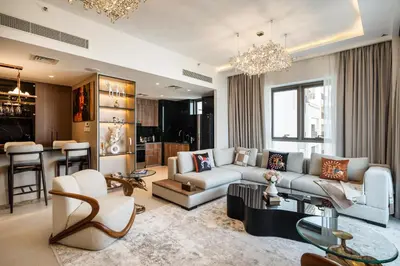 a living room with a couch and a table at Family Friendly luxurious Waterfront Apartment - By Dustay in Dubai