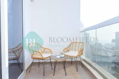 a group of chairs sitting on a balcony at Bloomfields Cozy Studio In Hera Tower Dubai in Dubai