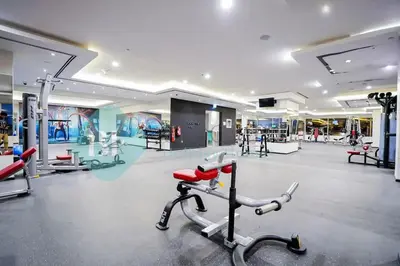 a gym with a treadmill in the middle of a room at Bloomfields Cozy Studio In Hera Tower Dubai in Dubai