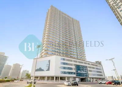 a tall building with a sign on the side of it at Bloomfields Cozy Studio In Hera Tower Dubai in Dubai
