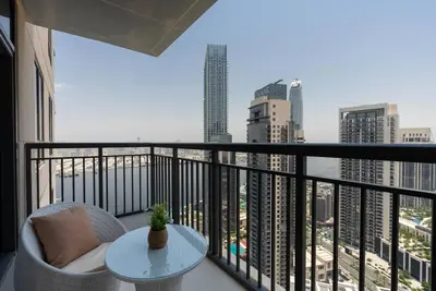 a balcony with a table and a view of a city at Skyline Huge 1 Bedroom Apartment Creek in Dubai