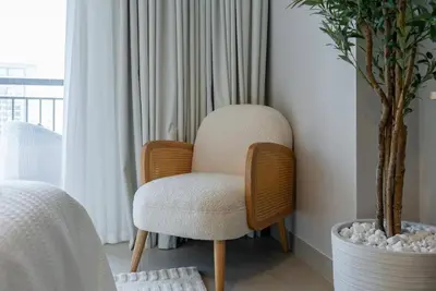 a chair sitting in a room next to a window at Skyline Huge 1 Bedroom Apartment Creek in Dubai