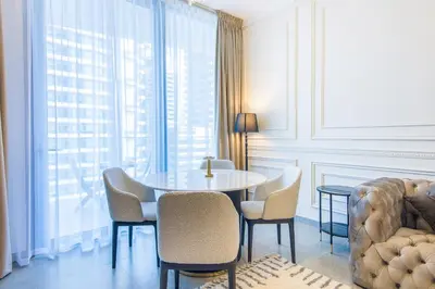 a dining room with a table and chairs and a window at Stella Maris, Dubai Marina- Luxurious 1-BR in Dubai