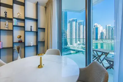 a dining room with a table and a view of the city at Stella Maris, Dubai Marina- Luxurious 1-BR in Dubai