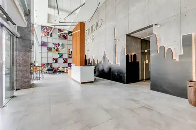 a lobby with a tile floor in a store at Knokey Dubai Marina Comfortable Apartments with Pool and Gym in Dubai
