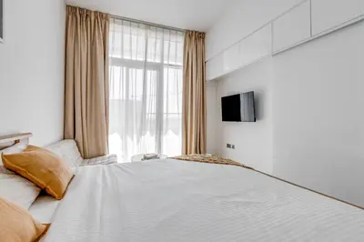 a bedroom with a large bed and a window at Knokey Dubai Marina Comfortable Apartments with Pool and Gym in Dubai