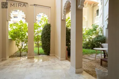 a hallway of a building with a table and a window at Mira Holiday Homes - Spacious 2 bedroom with patio in Palm Jumeirah in Dubai