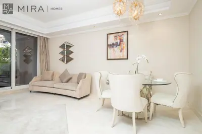 a living room with a couch and a table at Mira Holiday Homes - Spacious 2 bedroom with patio in Palm Jumeirah in Dubai