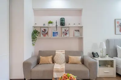 a living room with a couch and shelves on the wall at HAVN - Studio Dubai Marina View in Dubai