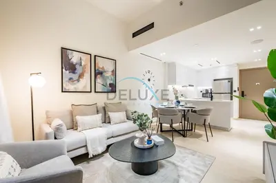 a living room with a couch and a table at Cozy 1BR at Binghatti Corner, Jumeirah Village Circle by Deluxe Holiday Homes in Dubai