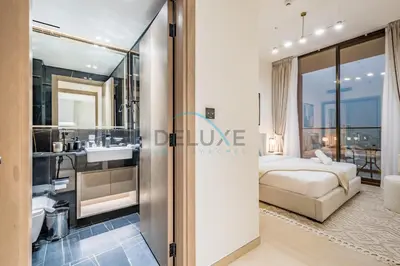 a hotel room with a bed and a bathroom at Cozy 1BR at Binghatti Corner, Jumeirah Village Circle by Deluxe Holiday Homes in Dubai
