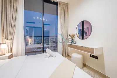 a bedroom with a bed and a large window at Cozy 1BR at Binghatti Corner, Jumeirah Village Circle by Deluxe Holiday Homes in Dubai